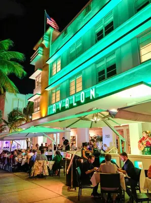 a group of people sitting outside of a building at Avalon Hotel in Miami Beach