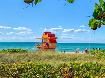 a lifeguard house on a beach with the ocean at Avalon Hotel in Miami Beach