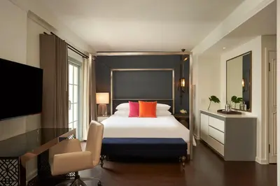 a bedroom with a large bed with orange pillows at Hotel Colonnade Coral Gables, Autograph Collection in Miami