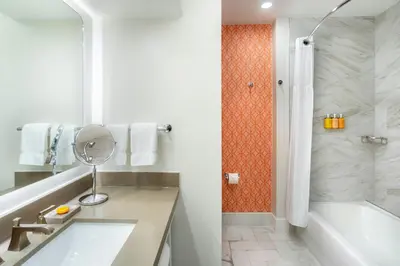 a bathroom with a tub and a sink and a shower at Hotel Colonnade Coral Gables, Autograph Collection in Miami