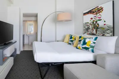 a white room with a bed and a couch at Hotel Colonnade Coral Gables, Autograph Collection in Miami