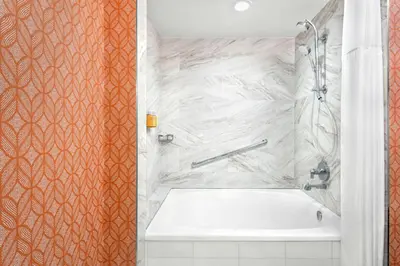 a bathroom with a white tub and a shower at Hotel Colonnade Coral Gables, Autograph Collection in Miami