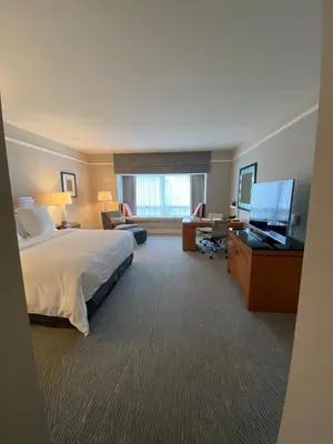 a hotel room with a bed and a flat screen tv at Private condo hotel at Four Seasons Brickell in Miami