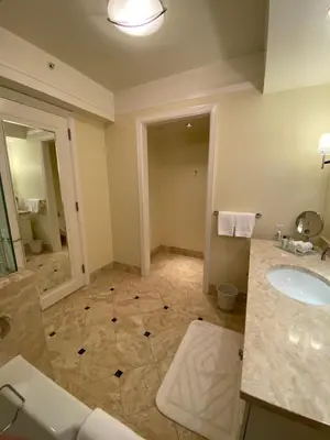 a large bathroom with a sink and a mirror at Private condo hotel at Four Seasons Brickell in Miami