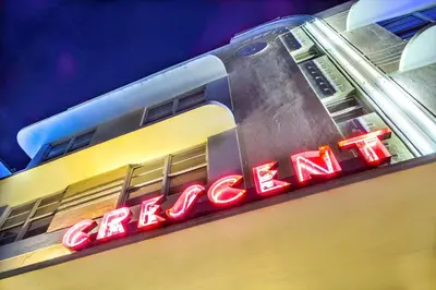 a neon sign on the side of a building at Hilton Vacation Club Crescent on South Beach Miami in Miami Beach