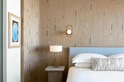 a bedroom with a bed and a lamp on a table at Kimpton - Hotel Palomar South Beach by IHG in Miami Beach
