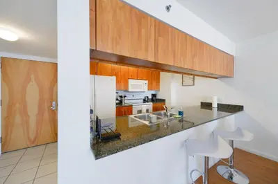 a kitchen with wooden cabinets and a counter top at Fabulous apartment in Brickell in Miami