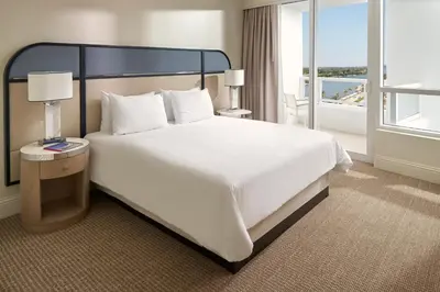 a hotel room with a large bed and a balcony at Fontainebleau Miami Beach in Miami Beach
