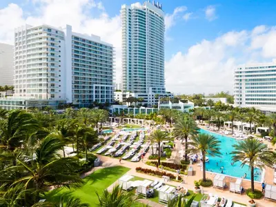 an aerial view of a resort with palm trees and a pool at Fontainebleau Miami Beach in Miami Beach