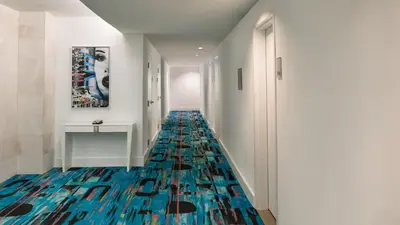 a hallway with a floor covered in blue glass bottles at YVE Hotel Miami in Miami