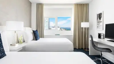 a hotel room with two beds and a window at YVE Hotel Miami in Miami