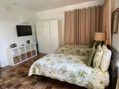 a small bedroom with a bed and a television at Harding Boutique Apartments in Miami Beach
