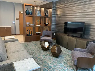 a living room with a couch and a flat screen tv at Wyndham Garden Miami International Airport in Miami