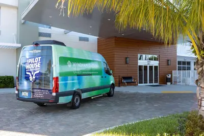 a green van parked in front of a building at Wyndham Garden Miami International Airport in Miami
