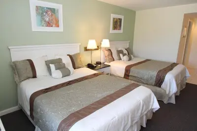 a hotel room with two beds and two lamps at Hotel Chateaubleau in Miami