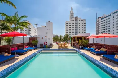 a pool with chairs and umbrellas on a building at Catalina Hotel & Beach Club in Miami Beach