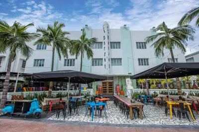 a group of tables and chairs in front of a building at Catalina Hotel & Beach Club in Miami Beach