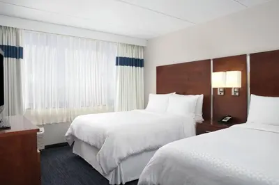 a hotel room with two beds and a television at Four Points by Sheraton Fort Lauderdale Airport/Cruise Port in Fort Lauderdale
