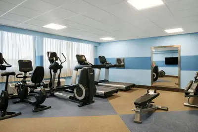 a gym with tread machines and a mirror at Four Points by Sheraton Fort Lauderdale Airport/Cruise Port in Fort Lauderdale