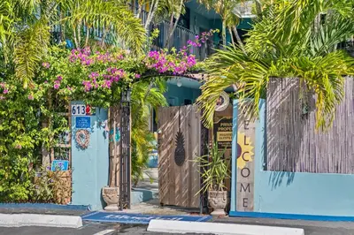 an entrance to a building with plants and flowers at Blue Bell Apartment Hotel in Fort Lauderdale
