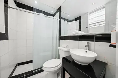 a bathroom with a white toilet and a sink at Shelley Hotel in Miami Beach