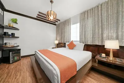 a bedroom with a large bed and a window at Hotel Chelsea in Miami Beach