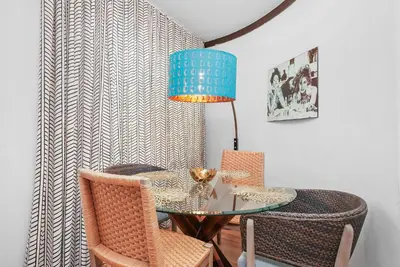 a dining room with a glass table and chairs at Metropole Suites South Beach in Miami Beach
