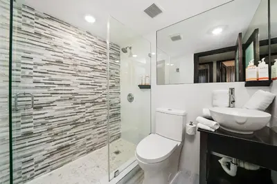 a bathroom with a toilet and a sink and a shower at Metropole Suites South Beach in Miami Beach