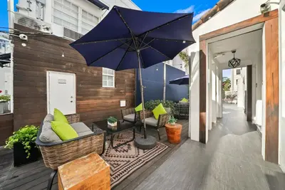 a patio with an umbrella and chairs and a table at Chesterfield Hotel & Suites in Miami Beach