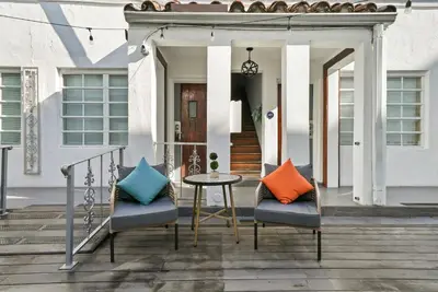 a porch with two chairs and a table at Chesterfield Hotel & Suites in Miami Beach