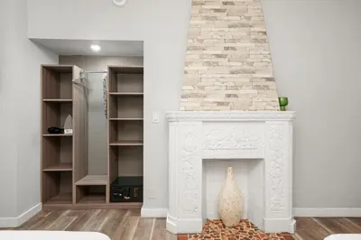 a fireplace in a living room with a white mantel at Chesterfield Hotel & Suites in Miami Beach