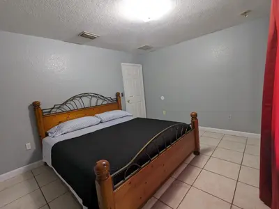 a bedroom with a wooden bed in a room at MiLuSol in Miami