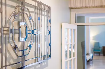 a glass wall in a living room next to a door at Dorchester Hotel & Suites in Miami Beach