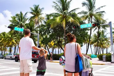 a group of people crossing a street at a traffic light at Majestic Hotel South Beach in Miami Beach