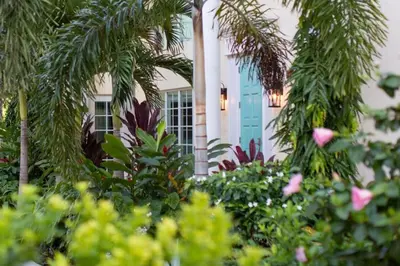 a house with a blue door and some plants at The Pillars Hotel & Club in Fort Lauderdale