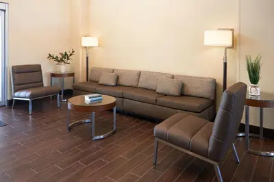 a living room with a couch and a table and chairs at TownePlace Suites Miami Kendall West in Kendall