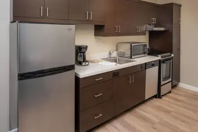 a kitchen with a refrigerator and a sink at TownePlace Suites Miami Kendall West in Kendall