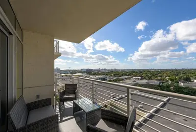a balcony with chairs and a view of a city at Modern 1 Bedroom Midtown Miami with FREE Parking in Miami