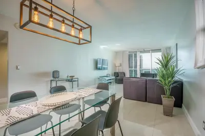 a dining room and living room with a table and chairs at OCEAN RESERVE 15th Floor - Gorgeous Ocean View - STR00907 in Miami Beach