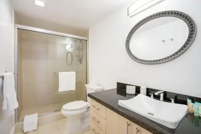 a bathroom with a toilet and a sink and a mirror at OCEAN RESERVE 15th Floor - Gorgeous Ocean View - STR00907 in Miami Beach