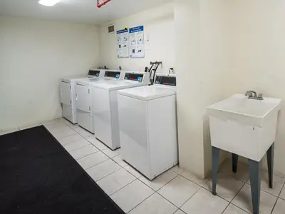 a laundry room with white washing machines and a sink at OCEAN RESERVE 15th Floor - Gorgeous Ocean View - STR00907 in Miami Beach