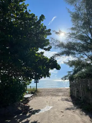 a sandy beach with a bench and the ocean at OCEAN RESERVE 15th Floor - Gorgeous Ocean View - STR00907 in Miami Beach