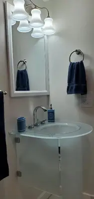 a bathroom with a sink with a mirror and a blue towel at Guayabita's House in Miami