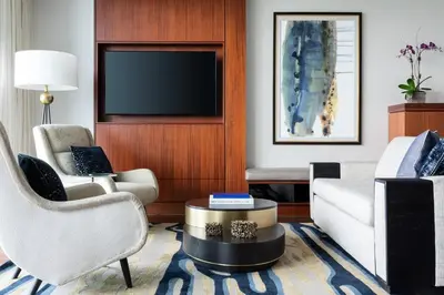 a living room with a couch and a tv at The Ritz-Carlton Bal Harbour, Miami in Miami Beach