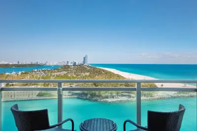 a view of the beach from the balcony of a condo at The Ritz-Carlton Bal Harbour, Miami in Miami Beach