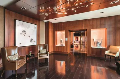 a lobby with chairs and vases on the wall at The Ritz-Carlton Bal Harbour, Miami in Miami Beach