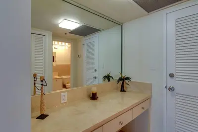 a bathroom with a sink and a large mirror at Alexander 1211 Beachfront Condo with Direct Beach Access, 2 Pools, Sauna, Gym in Miami Beach