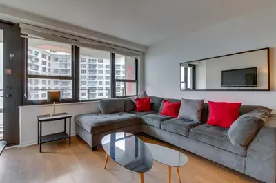 a living room with a couch and a tv at Alexander 1209 Beachfront condo with 2 pools , beach access, sauna, stores in Miami Beach