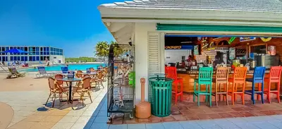 a restaurant with tables and chairs and a pool at Castle 922 in Miami Beach
