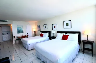 a hotel room with two beds with red pillows at Castle 1033 in Miami Beach
